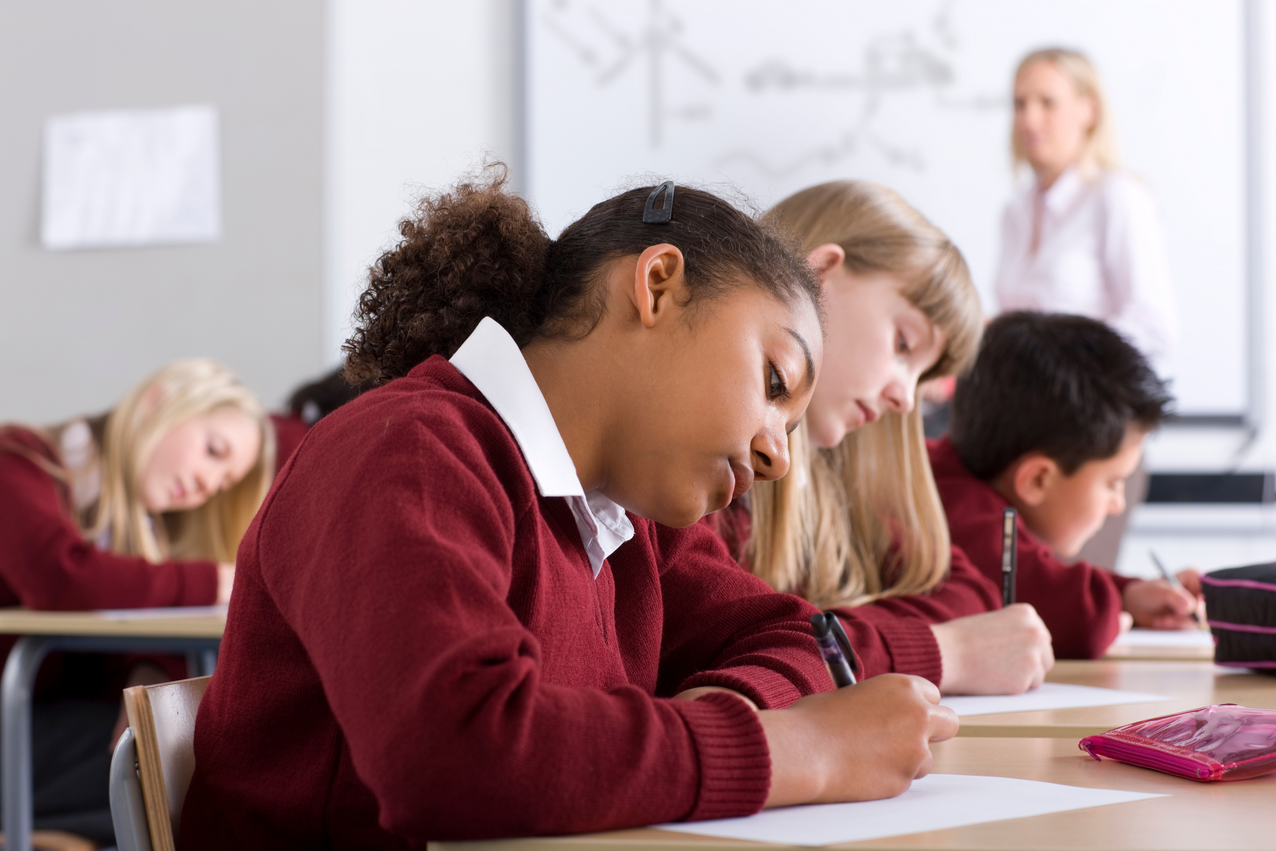 Sideview,Of?school,Children?sitting,In?a?row?on,Desks?under?selective,Focus?as,They,Take?a,Test?in?the?classroom?while,The